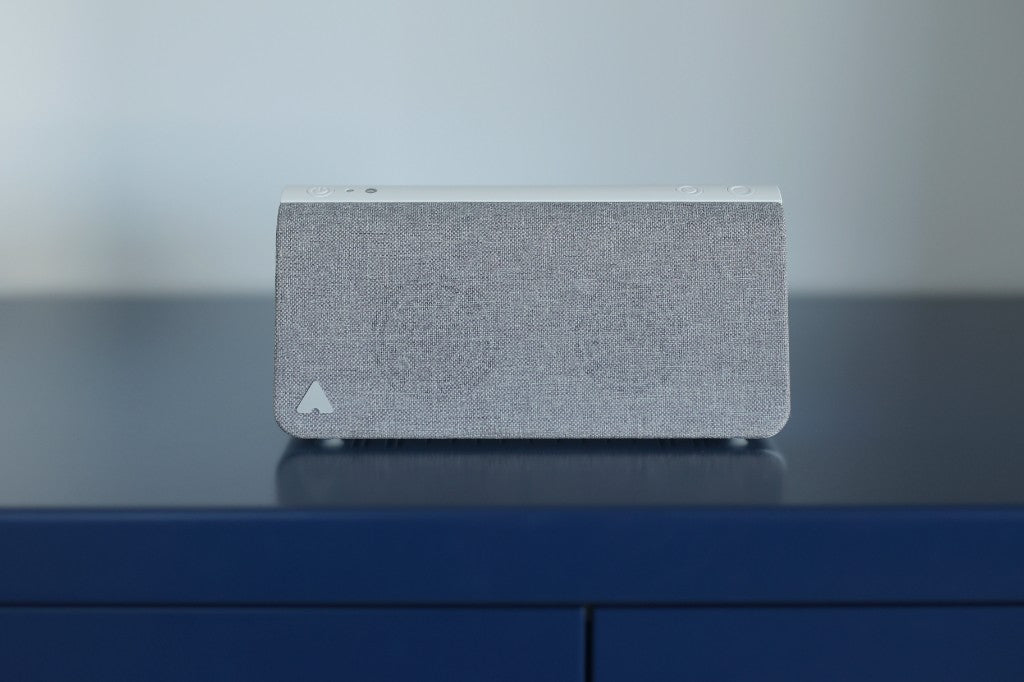 Kevin presence simulation device on a navy surface with fabric front and top controls